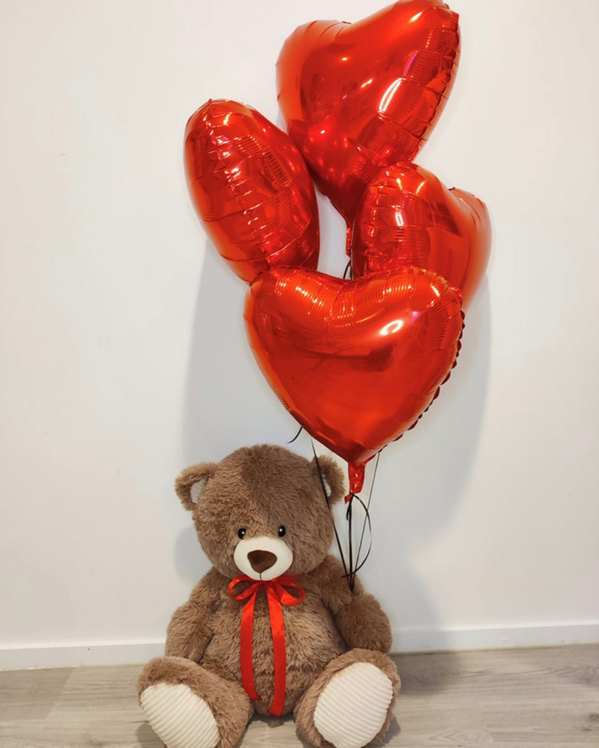 Bruine teddybeer met 4 helium ballonnen